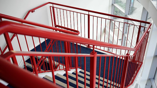 red metal stairs Red railings on blue stairs.